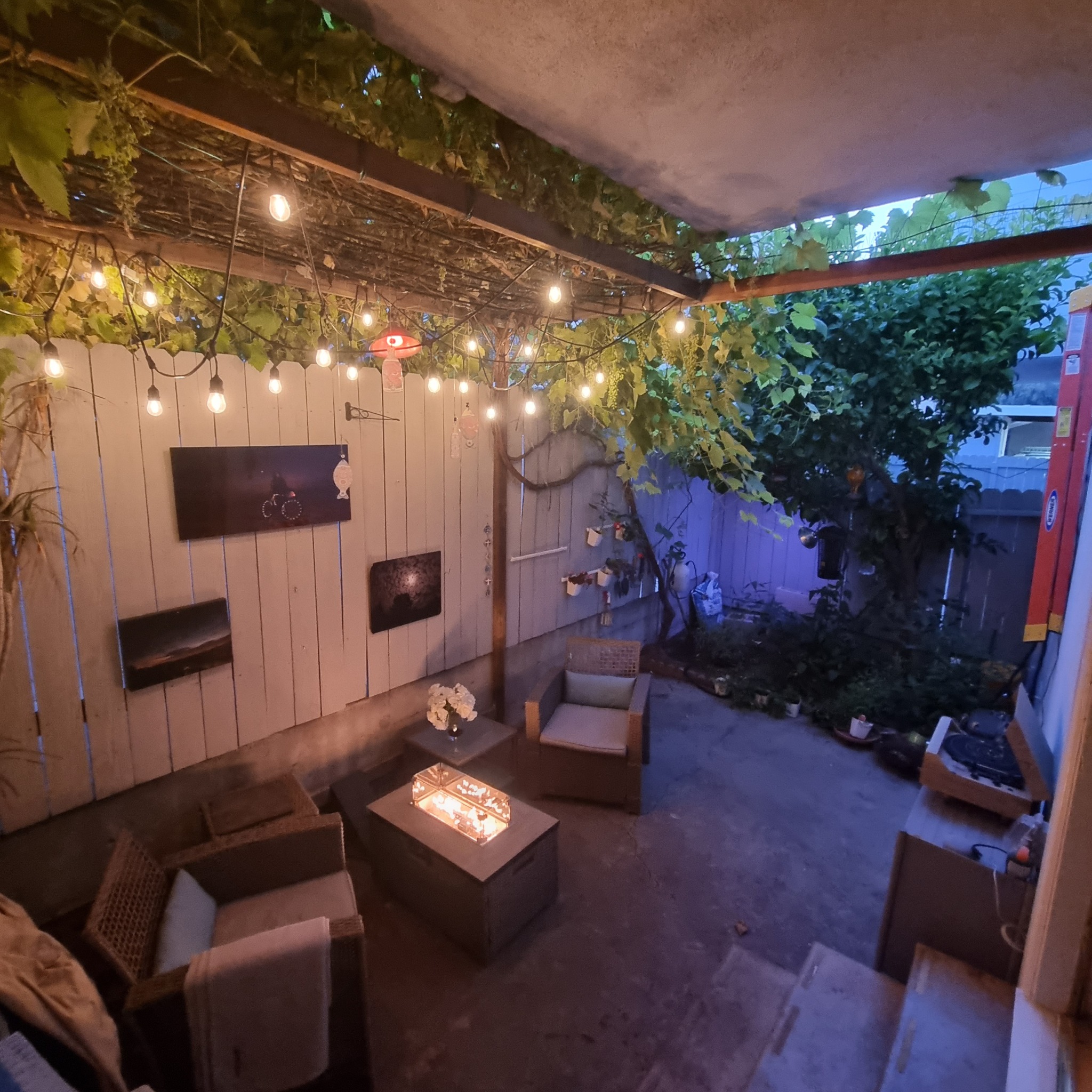 RedDoor3 private patio with warm string lights and firepit